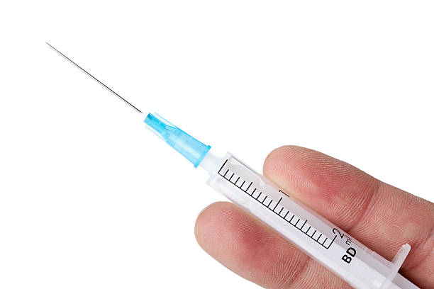 Syringe in hand Syringe in hand, closeup on white background mephedrone stock pictures, royalty-free photos & images