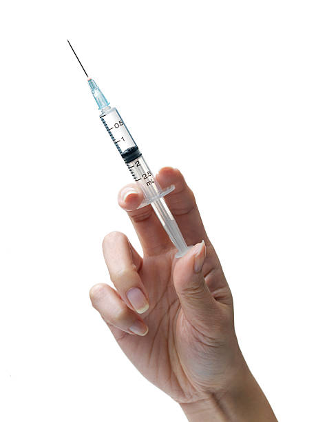Syringe Woman's hand with a syringe medical injection stock pictures, royalty-free photos & images