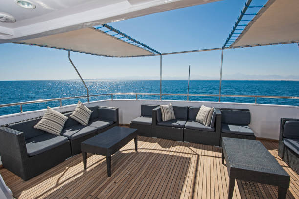 Table and chairs on deck of a luxury motor yacht stock photo