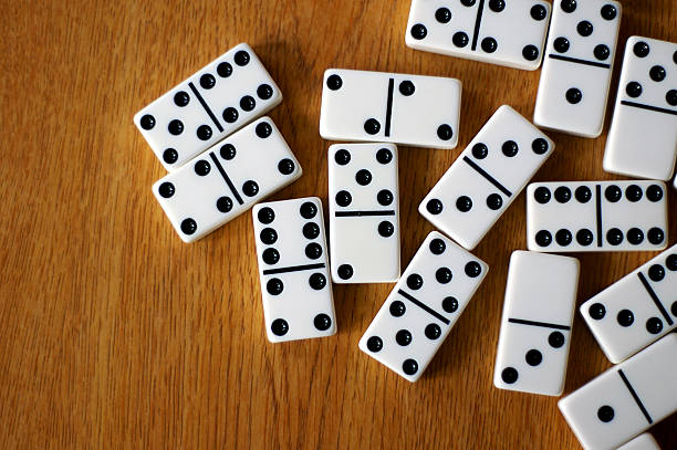 Table of Dominos A game of dominoes are easy.  Just match the numbers and try to end with multiples of 5's. domino stock pictures, royalty-free photos & images