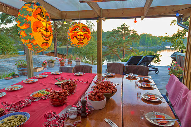 Table set for traditional crayfish party in Stockholm Archipelago. stock photo