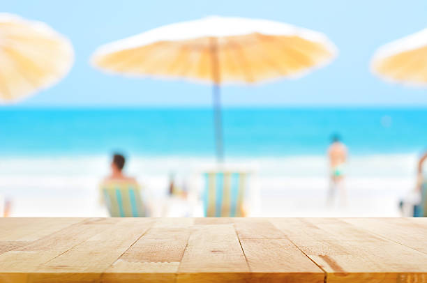 Table top on blurred background of people at the beach stock photo