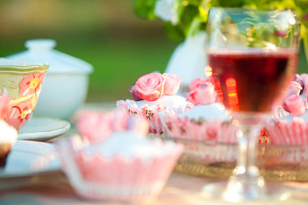 Table with cupcakes and wine stock photo