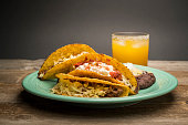 Photograph of a plate of tacos and a margarita.