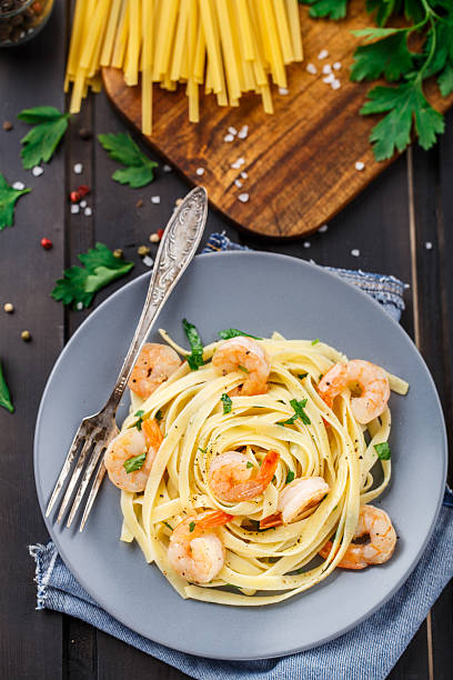Tagliatelle with shrimps and parsley stock photo