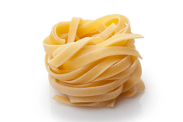 Tagliattele Pasta in form nest  isolated on white tagliatelle stock pictures, royalty-free photos & images