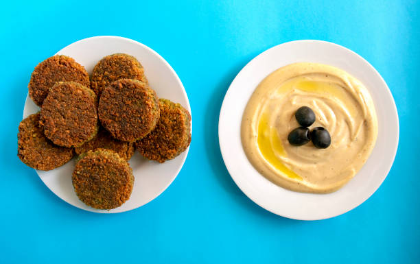 Tahina dipping and falafel on blue background. Famous traditional Arabic, Middle East, Israel cuisine. Tahina dipping and falafel on blue background. Flat lay, top view. Egipt food. coptic christianity stock pictures, royalty-free photos & images