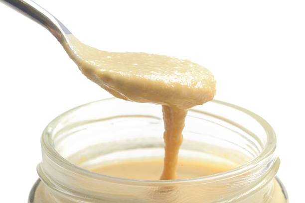 Tahini served from a jar stock photo