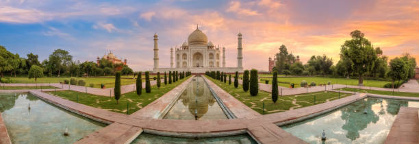 Taj Mahal with adjoining garden in panoramic view at sunrise at Agra, India stock photo
