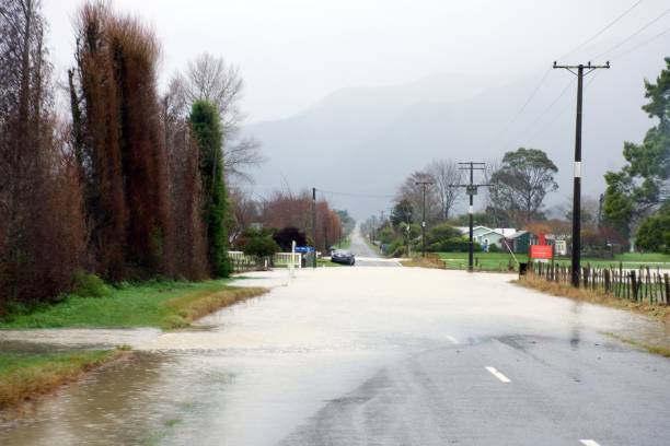 Takaka River floods onto Long Plain Road in the Tasman District, in New Zealand's South Island stock photo