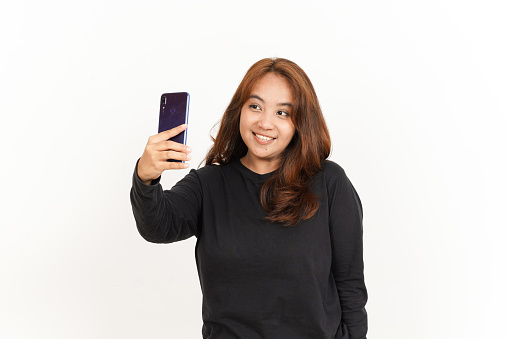 Take a Selfie using Smartphone Of Beautiful Asian Woman Wearing Black Shirt Isolated On White
