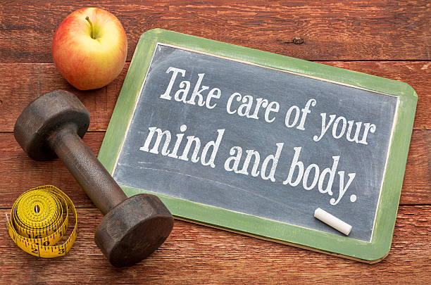 Take care of your mind and body Take care of your mind and body -  slate blackboard sign against weathered red painted barn wood with a dumbbell, apple and tape measure health for body mind stock pictures, royalty-free photos & images