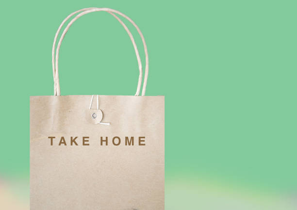 Take Home Paper Bag on Pastel Green Background Message take home on paper bag with pastel green background togo stock pictures, royalty-free photos & images