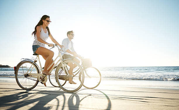 taking a ride in the sun - fietsen strand stockfoto's en -beelden