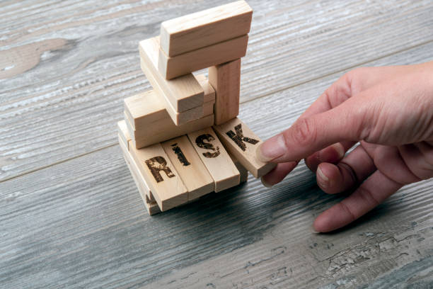 Taking one block from wooden blocks tower Taking one block from wooden blocks tower,risk managament risk stock pictures, royalty-free photos & images