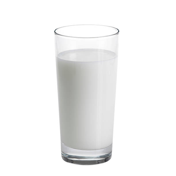 tall glass of milk against a white background - melk stockfoto's en -beelden