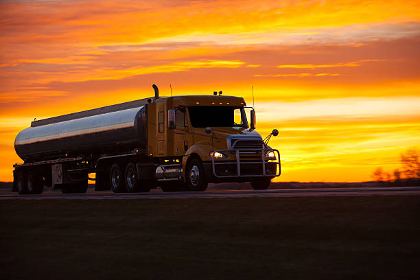 Tanker truck speeding along a highway at sunset. stock photo