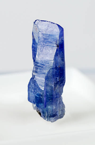 tanzanite Single crystal of blue tanzanite with a whole head on a light background zoisite stock pictures, royalty-free photos & images