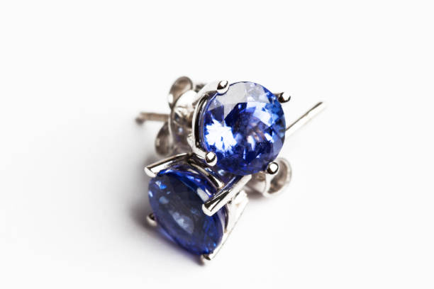 tanzanite Tanzanite earring on white backgound. zoisite stock pictures, royalty-free photos & images