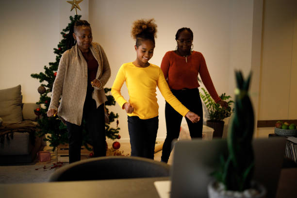 Tap tok Three female members of an African American family have lots of fun dancing Tik Tok routines on Christmas day. tiktok stock pictures, royalty-free photos & images