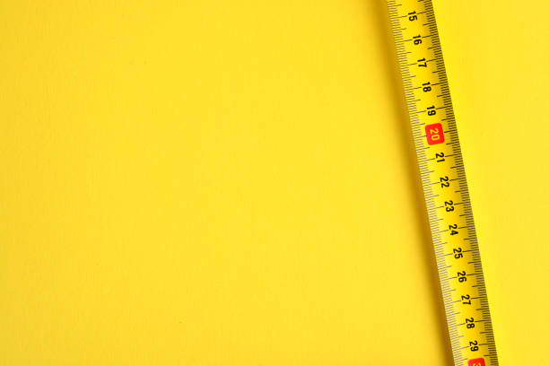 Tape measure scale on a yellow background. Copy space. Tape measure scale on a yellow background. Copy space. instrument of measurement stock pictures, royalty-free photos & images