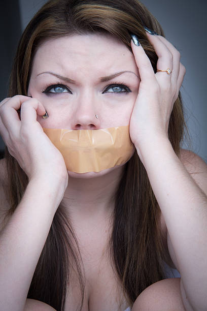 Taped On Mouth Scared Woman With Taped Mouth human mouth gag adhesive tape women stock pictures, royalty-free photos & images