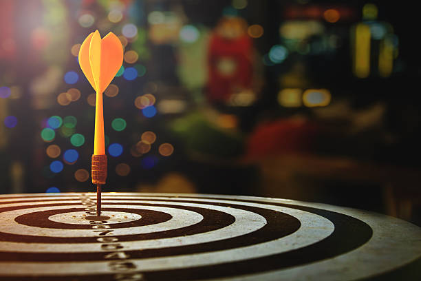 target dart with arrow over blurred Christmas background stock photo