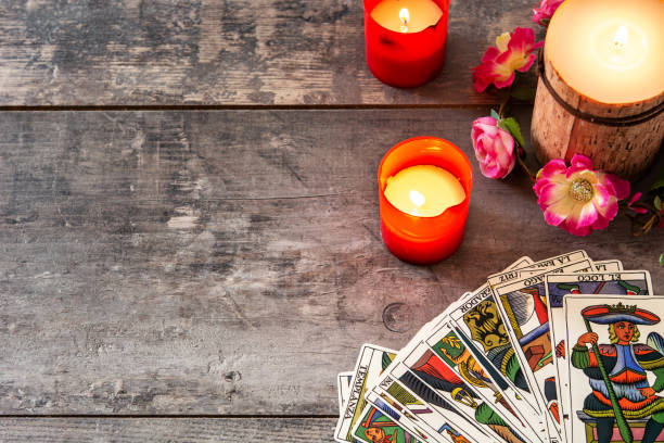 Tarot cards on wooden table with candles stock photo