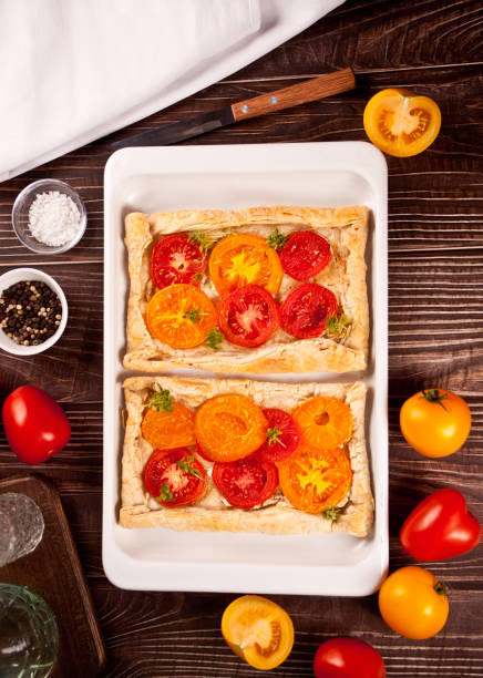 Tart puff pastry quiche with roasted tomatoes stock photo
