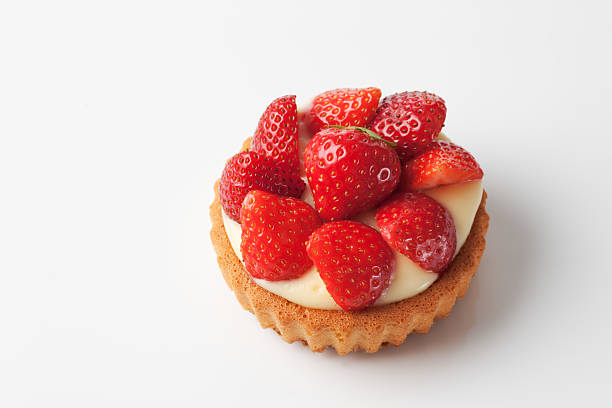 Tartlet filled with vanilla custard strawberries on top on white stock photo