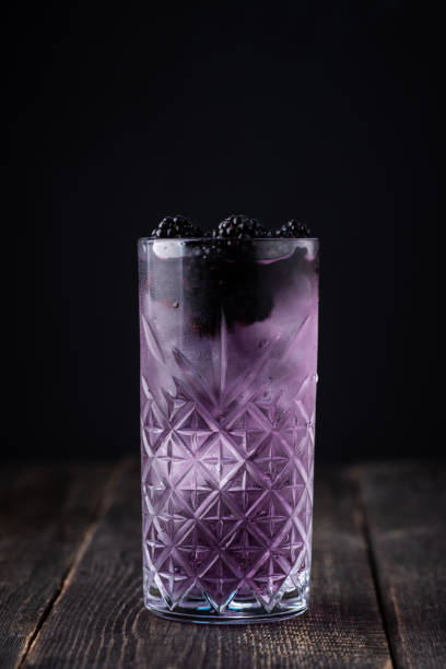 Taste of forest with gin based cocktail with blackberry liqueur and berries. Selective focus. stock photo