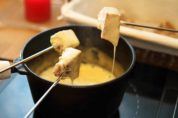 Tasty cheese fondue on skewers stock photo