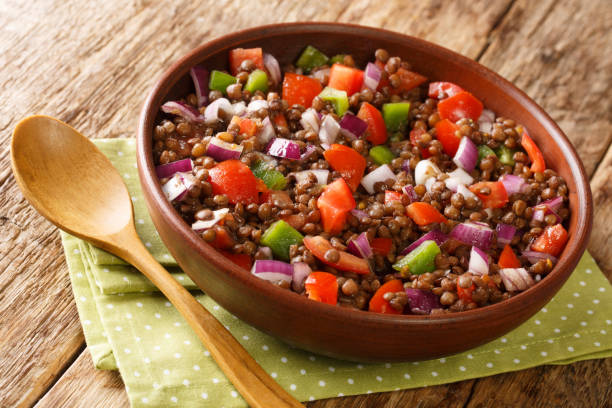 Tasty Green Lentil Salad Azifa close up in the plate. Horizontal stock photo