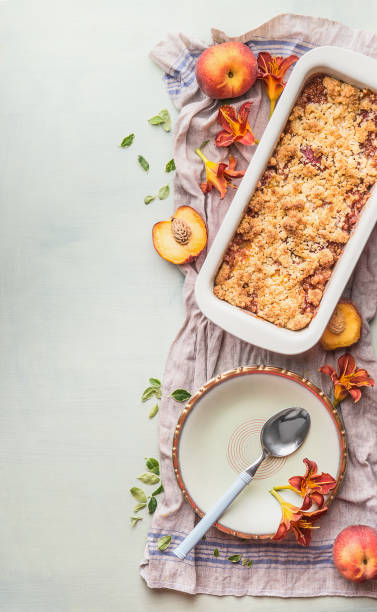 Tasty homemade peach cobbler with ingredients stock photo