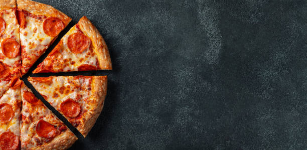 tasty pepperoni pizza and cooking ingredients tomatoes basil on black concrete background. top view of hot pepperoni pizza. with copy space for text. flat lay. banner - pizza table imagens e fotografias de stock