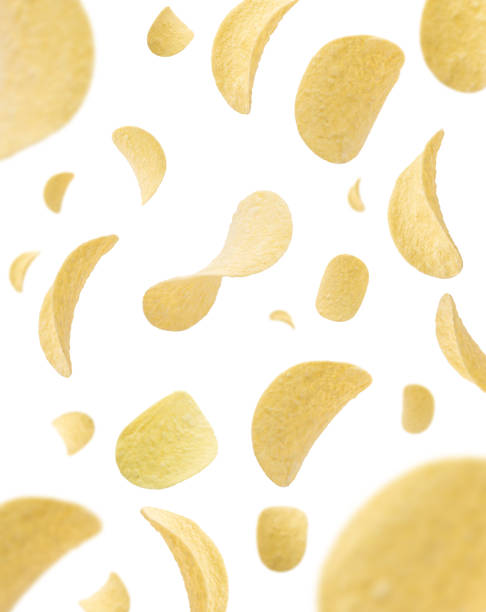 Tasty potato chips falling isolated on white background. Selective focus stock photo