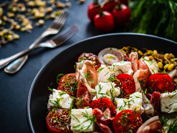 tasty salad ham feta cheese sprouts and fresh vegetables on black picture - The Tasty Hub