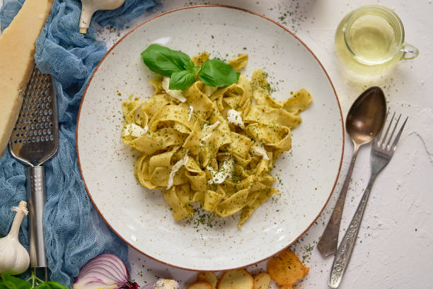 Tasty tagliatelle pasta with basil and green pesto stock photo