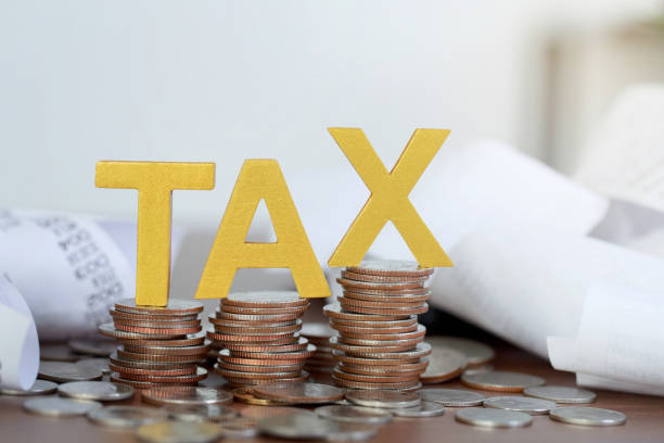 Tax Concept.Word tax put on coins and paper bill with coins on desks. Tax Concept.Word tax put on coins and paper bill with coins on desks. tax stock pictures, royalty-free photos & images
