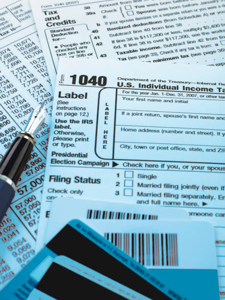 1040 tax form and credit cards stock photo