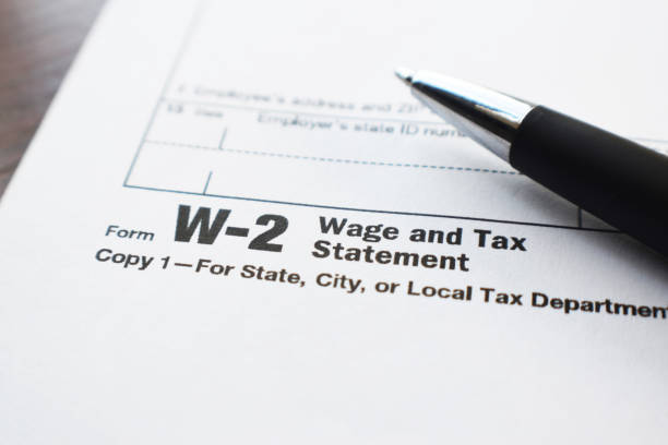 Tax Form W-2 Close Up With Pen High Quality Tax Form W-2 Close Up With Pen income tax stock pictures, royalty-free photos & images