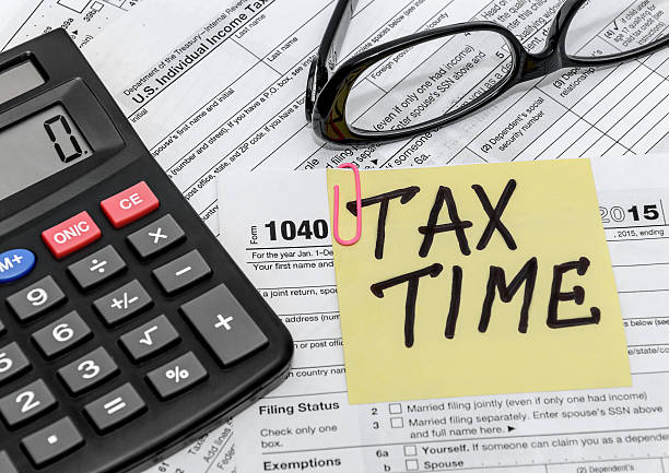 tax form with callculator and glasses tax form with callculator and glasses filing documents stock pictures, royalty-free photos & images
