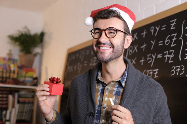 Teacher during Christmas with Santa Claus hat stock photo