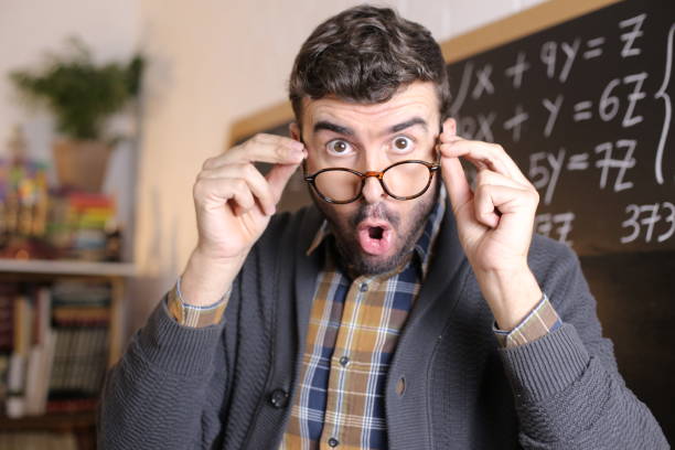 Teacher opening mouth in disbelief stock photo