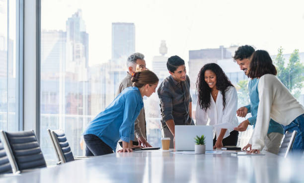 Team of business people working together in a board room stock photo