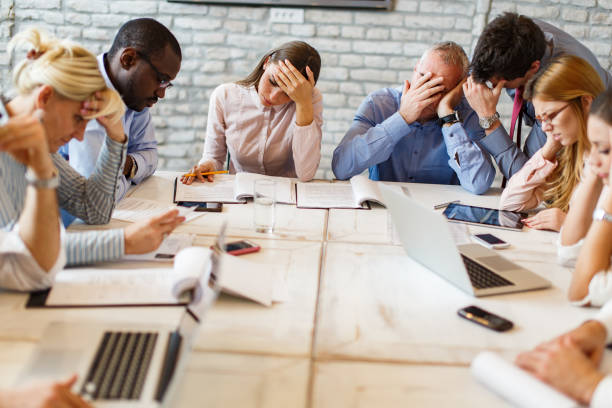 Team of entrepreneurs having problems on a meeting in board room. stock photo