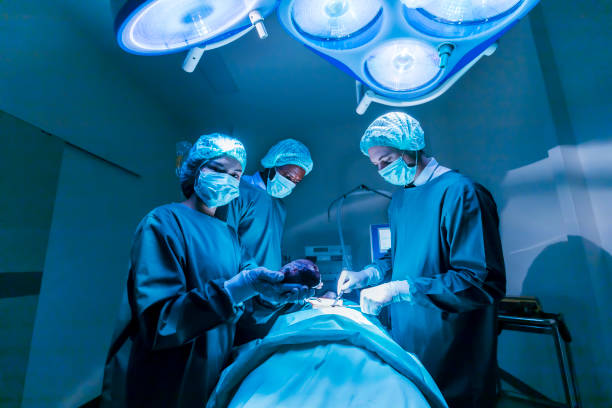 Team of surgeon doctors are performing heart surgery operation for patient from organ donor to save more life in emergency surgical room stock photo
