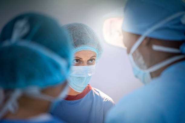 Team of surgeons in blue scrubs at emergency room stock photo