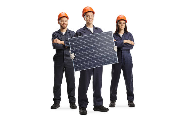 Team of workers in uniforms presenting a solar panel stock photo