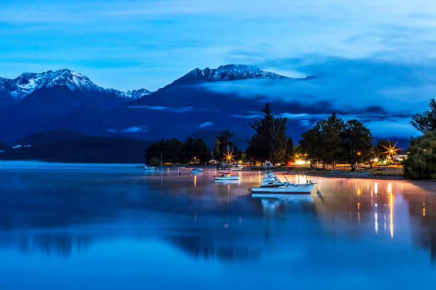 TeAnau New Zealand Dawn with Boats and Mountains stock photo